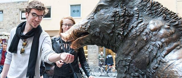 Jack Sherman interacting with a sculpture in Florence, Italy